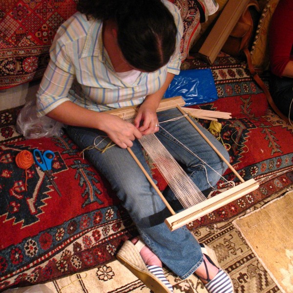 A student works on a small rug at Hayko Fine Rugs & Tapestries.